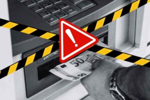 bancomat, segnale di pericolo e nastro nero e giallo