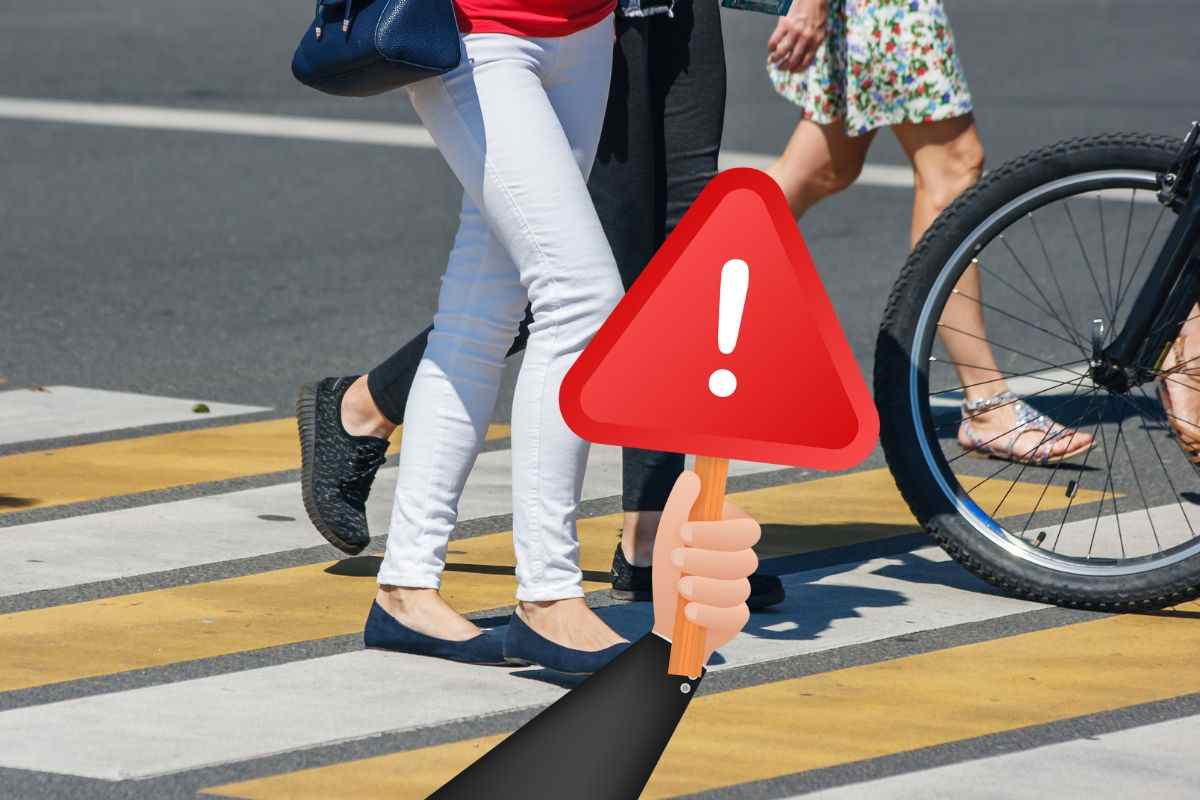 Persone attraversano le strisce pedonali