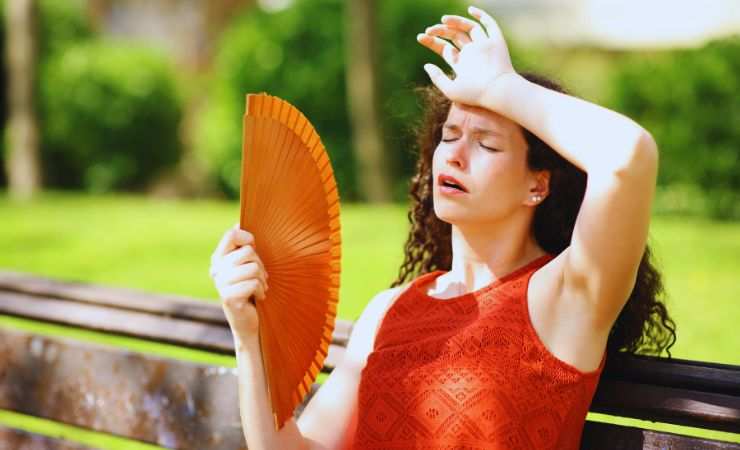 ragazza con ventaglio per il caldo